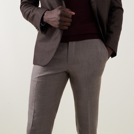 Model wearing Slowear beige formal wool trousers, styled with a taupe blazer and dark burgundy knit sweater.