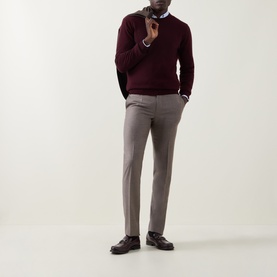 Model wearing Slowear beige wool formal trousers, styled with a burgundy crew-neck jumper and dark leather loafers.