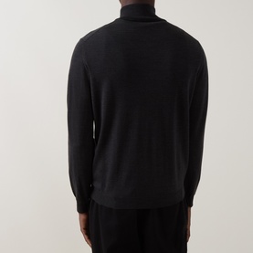 Model wearing Slowear charcoal half zip knit, rear view, showing ribbed cuffs and high neck collar