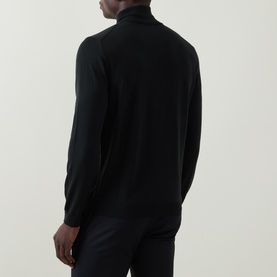 Model wearing Slowear green wool half zip knit, back view, with tailored black trousers