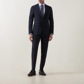 Model wearing Strellson navy suit jacket with matching trousers, light blue shirt, patterned tie, and dark leather shoes.