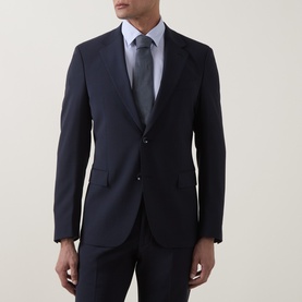 Model wearing Strellson navy suit jacket, styled with light blue shirt and grey tie