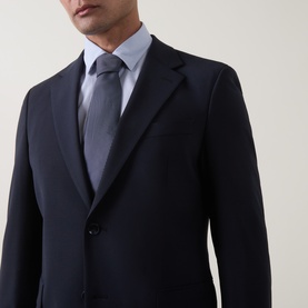 Model wearing Strellson navy suit jacket, styled with a light blue shirt and grey tie