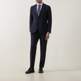 Model wearing Strellson navy suit jacket and matching trousers, styled with a light blue shirt, grey tie and black leather shoes.