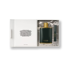Victoria Beckham Fragrance Set in open white gift box, featuring large dark green bottle with gold cap and miniature black rollerball