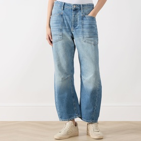 Model wearing Free People Minimalist Moxi Barrel-Leg Jeans in County Fair mid-wash denim with front patch pockets and contrast stitching