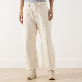 Model wearing Free People We The Free Minimalist Moxie Low-Rise Barrel Jeans in Dusty Roads, styled with beige lace-up boots