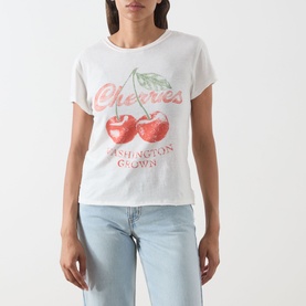 Model wearing Free People cherry combo graphic tee with red cherry print, styled with light blue jeans.