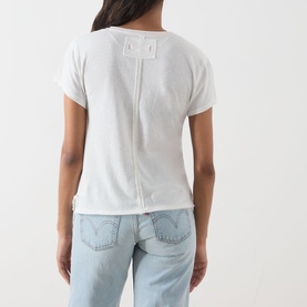 Model wearing Free People top in Cherry Combo, back view, with seam detail, styled with light-wash Levi's jeans.