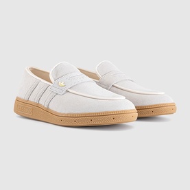 Adidas loafer trainers in Wonder White with ribbed side stripes, gold logo detail, and tan gum sole