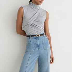 Model wearing Reiss grey marl sleeveless mock-neck wrap top, styled with light blue wide-leg jeans and brown belt.