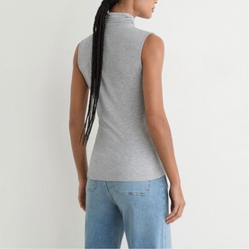 Model wearing Reiss grey marl sleeveless ribbed high-neck top, styled with light blue jeans, seen from behind.