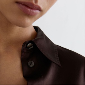 Model wearing Reiss grape burgundy satin shirt, close-up of point collar with dark shell buttons