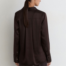 Model wearing Reiss grape burgundy long-sleeve satin blouse, back view, with button cuffs and centre pleat detail.