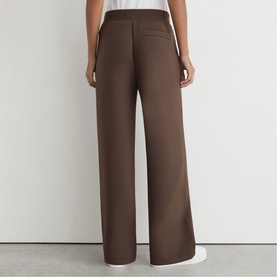 Model wearing Reiss mocha brown wide-leg trousers, rear view, styled with a white top.