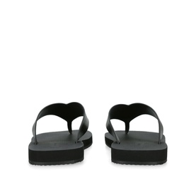 THE ROW Ginza Leather Slides in black, rear view showing thong toe post and flat black rubber sole