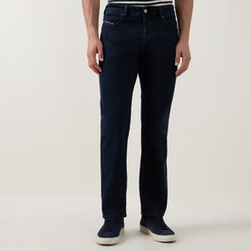 Model wearing Diesel 3049 dark blue slim jeans, styled with white T-shirt and blue trainers