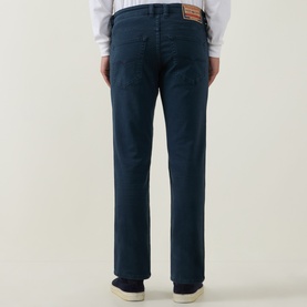 Model wearing Diesel 1993 D-VYL Slim-Leg Jeans in blue, dark wash, slim fit, five-pocket styling, rear view with logo patch detail