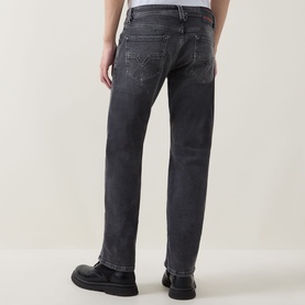 Model wearing Diesel 3049 dark grey straight jeans, rear view, styled with black leather shoes.
