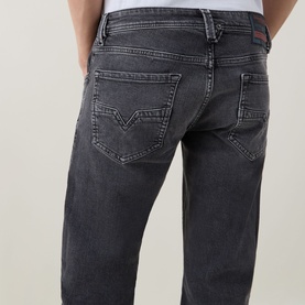 Model wearing Diesel 3049 dark grey straight jeans, rear view showing signature stitched back pockets and faded wash detail.