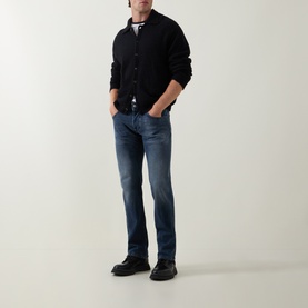 Model wearing Diesel 3049 dark blue straight jeans, styled with black cardigan, striped tee, and black chunky shoes.