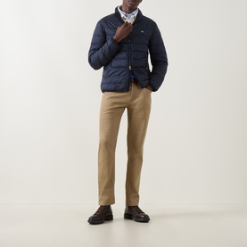 Model wearing Gant Evening Blue quilted down casual jacket, styled with beige chinos and dark brown leather shoes