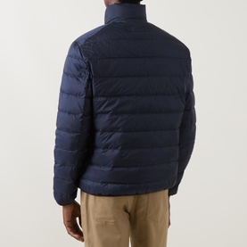 Model wearing Gant Evening Blue quilted down casual jacket, rear view, styled with beige trousers