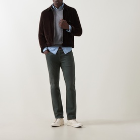 Model wearing Gant Classic Shield Sweater in dark grey melange crew neck, styled with dark brown jacket, green trousers, and white trainers.