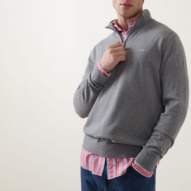 Model wearing Gant Shield Logo Half-Zip Sweatshirt in dark grey melange with funnel neck, styled over a pink striped shirt.