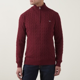 Model wearing Gant Deep Grape Wine cotton cable-knit half-zip jumper with ribbed cuffs and hem, styled with dark jeans.
