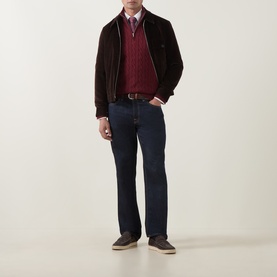 Model wearing Gant Deep Grape Wine cotton half-zip knit, styled with dark brown suede jacket, blue shirt, navy jeans and taupe shoes.