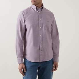 Model wearing Gant Reg Shirt in deep grape wine, long-sleeved cotton shirt with button-down collar and chest pocket, styled with blue jeans