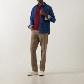 Model wearing Gant Deep Grape Wine Regular Polo in cotton, styled with denim overshirt, tan chinos and white trainers.