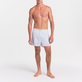 Model wearing Skims Boxers 1Pk in Platinum Double Stripe, slim-fit woven style with branded elastic waistband