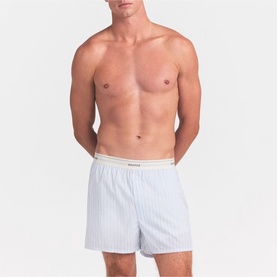 Model wearing Skims Boxers 1Pk in Platinum Double Stripe, featuring a striped woven fabric with a contrast waistband.