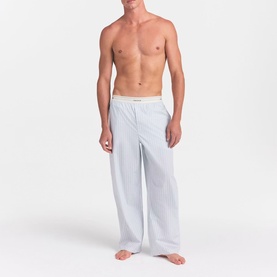 Model wearing Skims Pyjama Bottom in Platinum Double Stripe, relaxed fit with elasticated waistband, shown from waist down.