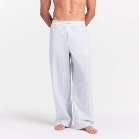 Model wearing Skims Pyjama Bottom in Platinum Double Stripe, relaxed wide-leg fit with branded elasticated waistband.