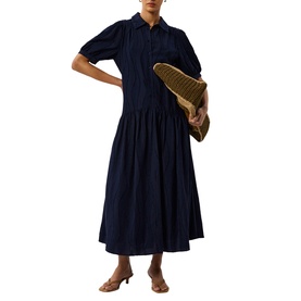 Model wearing Whistles blue midi shirt dress with gathered skirt, styled with a woven clutch bag and strappy heeled sandals