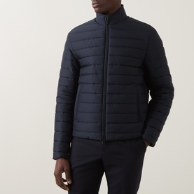 Model wearing Canali navy casual jacket with quilted panels, zip fastening and stand collar, styled with navy trousers.