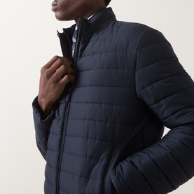 Model wearing Canali navy quilted casual jacket with funnel neck and zip fastening, styled with checked shirt collar visible