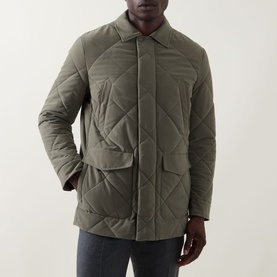 Model wearing Canali Diamond Quilted Field Jacket in green, featuring diamond quilting, pointed collar, chest and flap pockets, styled with grey