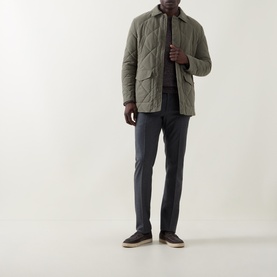 Model wearing Canali Diamond Quilted Field Jacket in green with diamond pattern, styled with grey trousers and dark loafers.