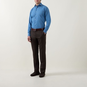 Model wearing Canali light blue cotton-linen casual shirt with dark brown trousers and brown leather belt.