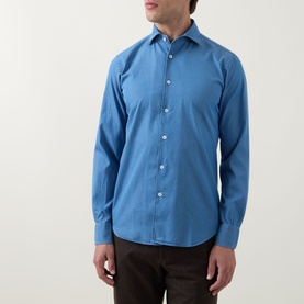 Model wearing Canali light blue cotton-linen casual shirt with spread collar and button front, styled with dark brown trousers