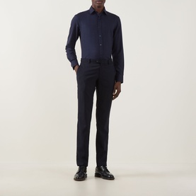 Model wearing Canali Flannel Herringbone Shirt in navy with point collar and long sleeves, styled with navy trousers and black shoes.