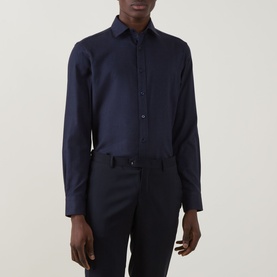 Model wearing Canali Flannel Herringbone Shirt in navy, point collar, long sleeves, front button fastening, styled with dark trousers.