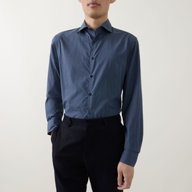 Model wearing Canali blue casual shirt in cotton-lyocell blend, styled with black tailored trousers