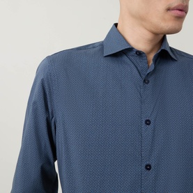 Model wearing Canali blue casual shirt with tonal micro-pattern, long sleeves and spread collar, in cotton-lyocell blend