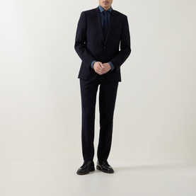 Model wearing Canali blue casual shirt, styled with navy suit and black leather dress shoes