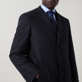 Model wearing Canali navy wool coat, styled with blue shirt and patterned tie, three-button front fastening